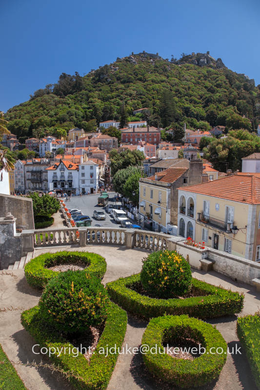 Palace gardens and Sintra historical old town with Moorish castle on the hill behind, Portugal